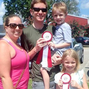 Photo of family with ribbons at the Memphis Area Master Gardeners Great Tomato Contest